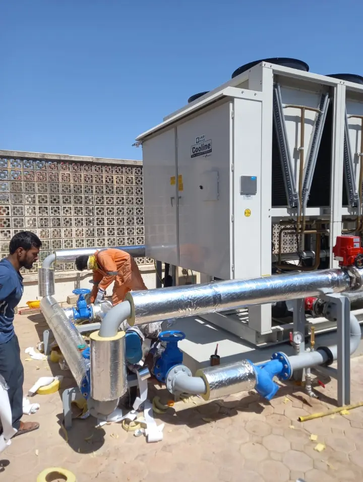 Our technicians installing chilled water piping at an air-cooled chiller in Salalah